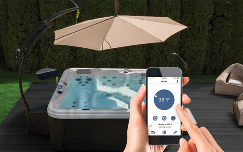 Smartphone controlling Wellis Porto Holiday Let Spa remotely, highlighting app connectivity and temperature control.
