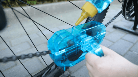 Person using Bicycle Chain Cleaner for maintaining the bicycle