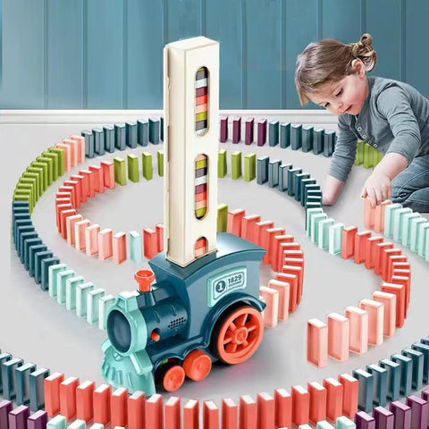 Girl playing with Domino Train with blocks