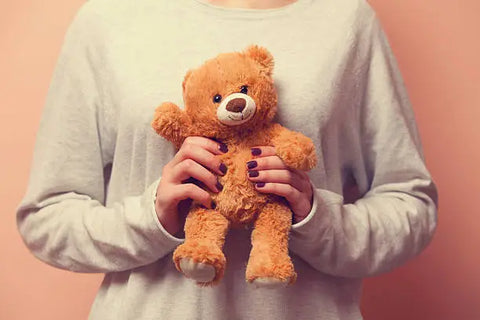 person holding teddy bear