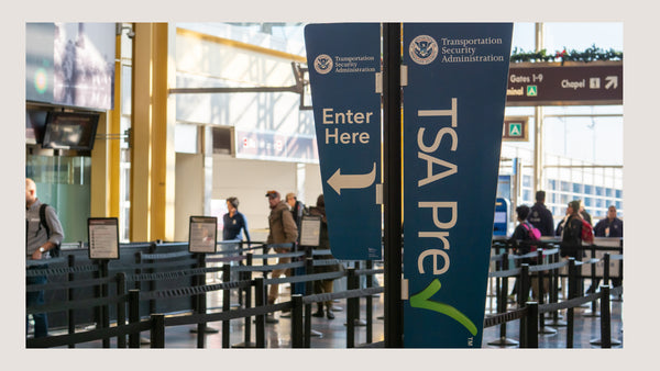 Security line in the airport with a prominent TSA sign