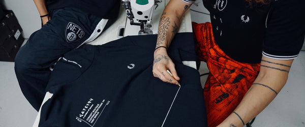 Fred Perry Blog Post Banner Man Sewing on Sweatshirt Gate Collab