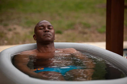 Man having a cold plunge on a Cryospring Cold + Hot Plunge System