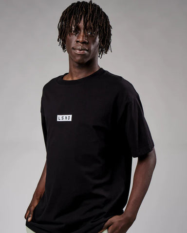 Model wears black oversize LSKD tshirt shown from waist up