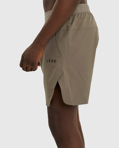 Model wears LSKD brown performance shorts. Shown from waist to knee