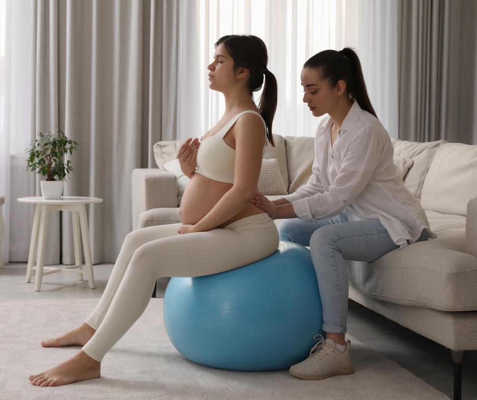 Pregnant woman on an exercise ball being massaged