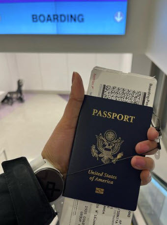 hand holding passport before boarding a flight