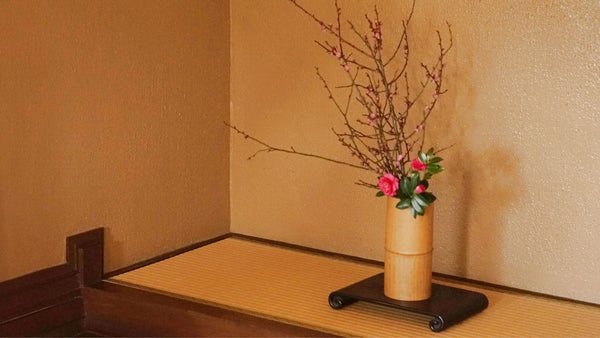 Japanese vase with ikebana arrangement in minimalist room