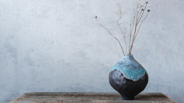 Blue Japanese vase with minimal flower arrangement