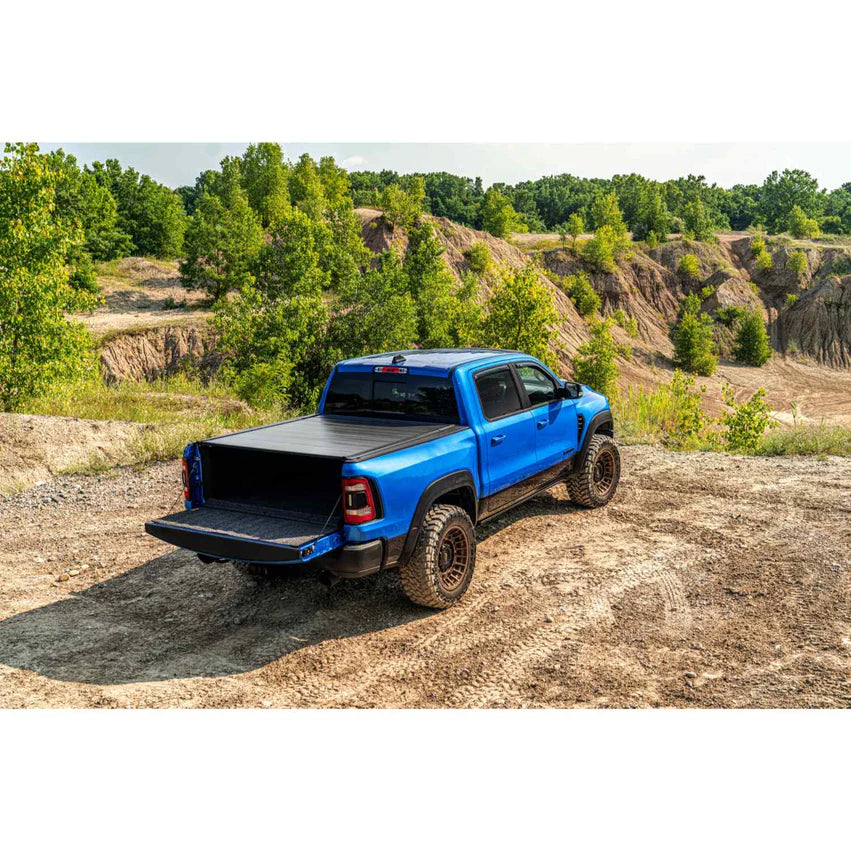 Retrax IX Ford Tonneau Cover Installed on a blue ford truck with tailgate open in a lifestyle view