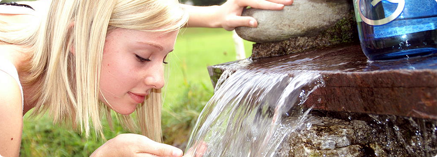 Lady drinking water revitalized by Grander