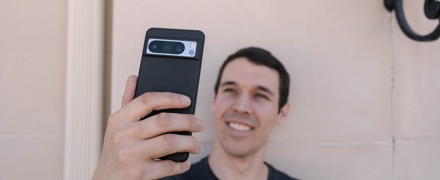 A MAN HOLDING PIXEL 8 PRO IN A SUPER THIN CASE