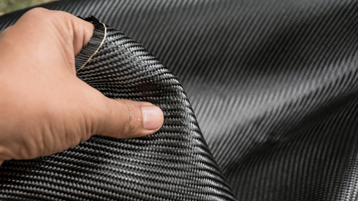 a male hand holding premium 600d aramid fiber that we used to craft our s24 ultra case
