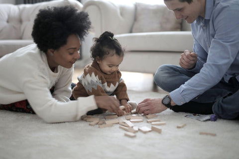 parents playing with child