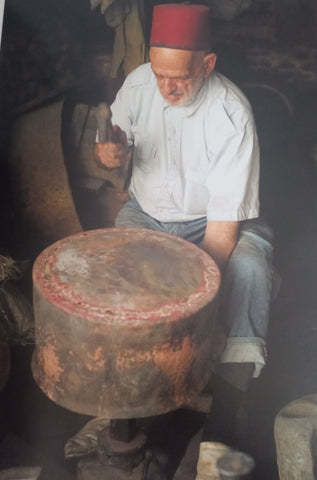 Old moroccan artisan working on iron