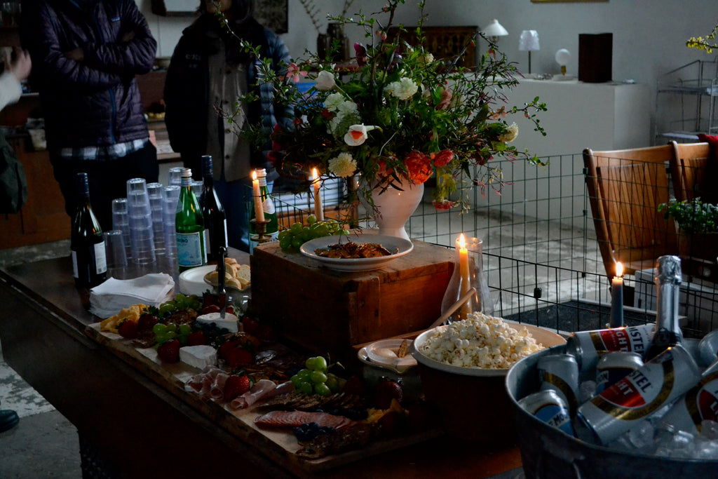 The refreshments table, alight with candles and decorated with a floral arrangement by Flowerkraut, at Quittner