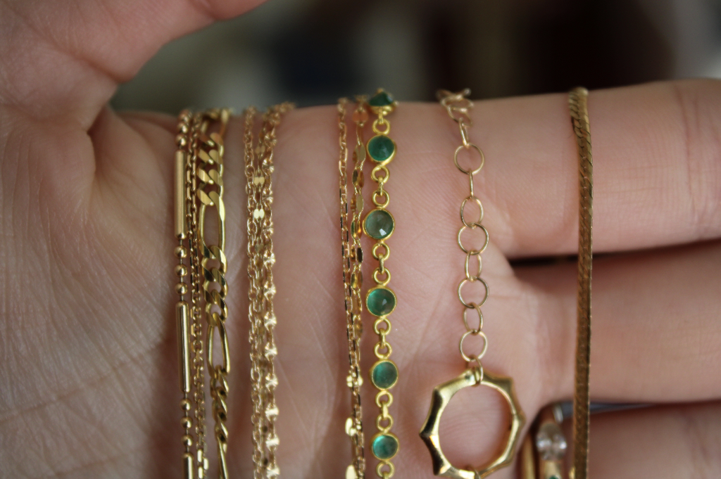 Dunia Simunovic emerald and gold chains