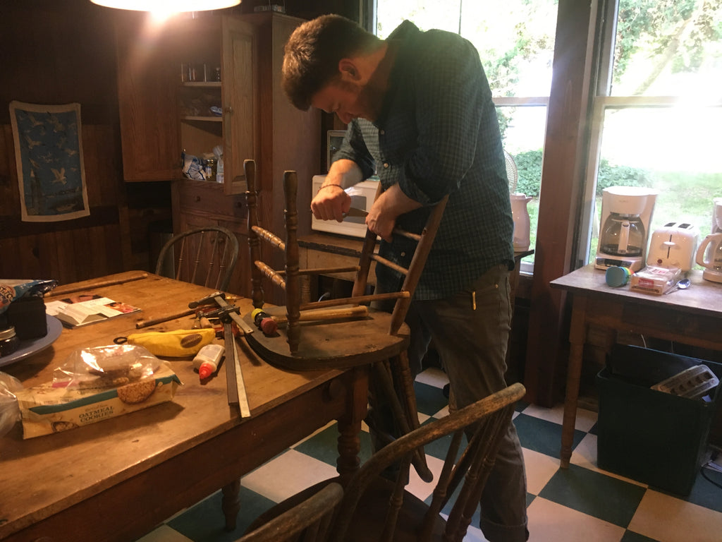 Ben repairing a chair in the kitchen
