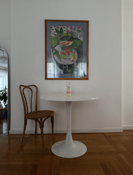 new york apartment furnished with used and found vintage table, chair, and art print