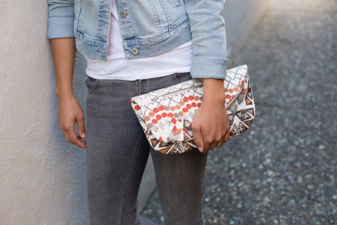 Woman holding Aztec Brick fanny pack as clutch