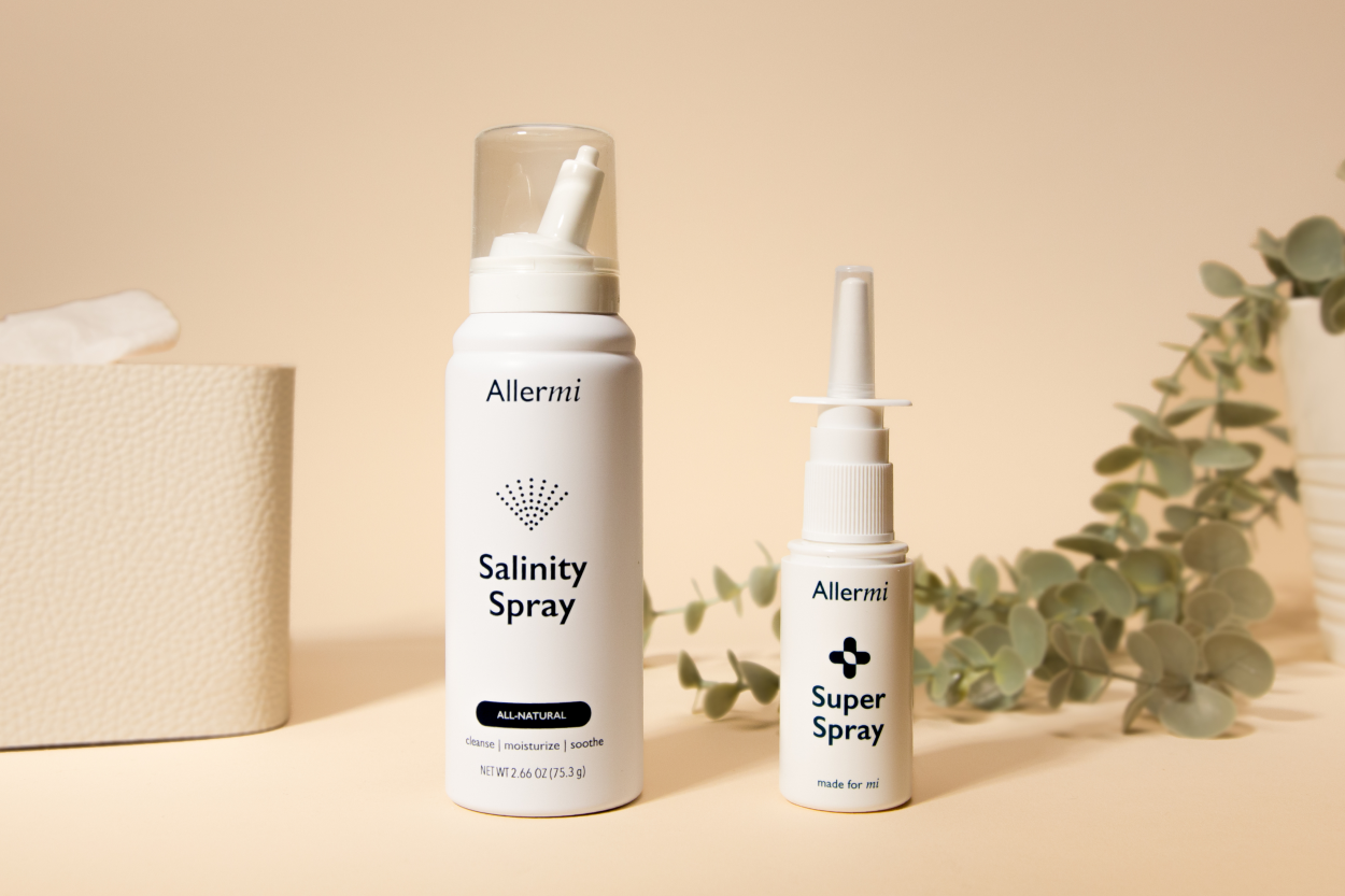 Allermi Nasal Spray in a tableau with a light background and eucalyptus leaves