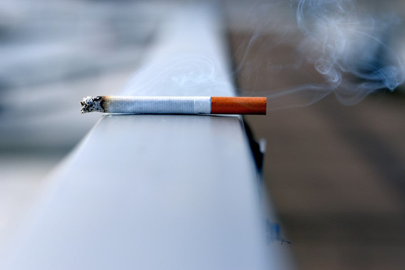 A white cigarette on a ledge