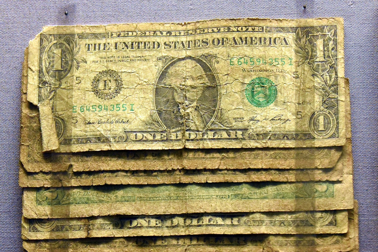 Tattered and soiled dollar bills
