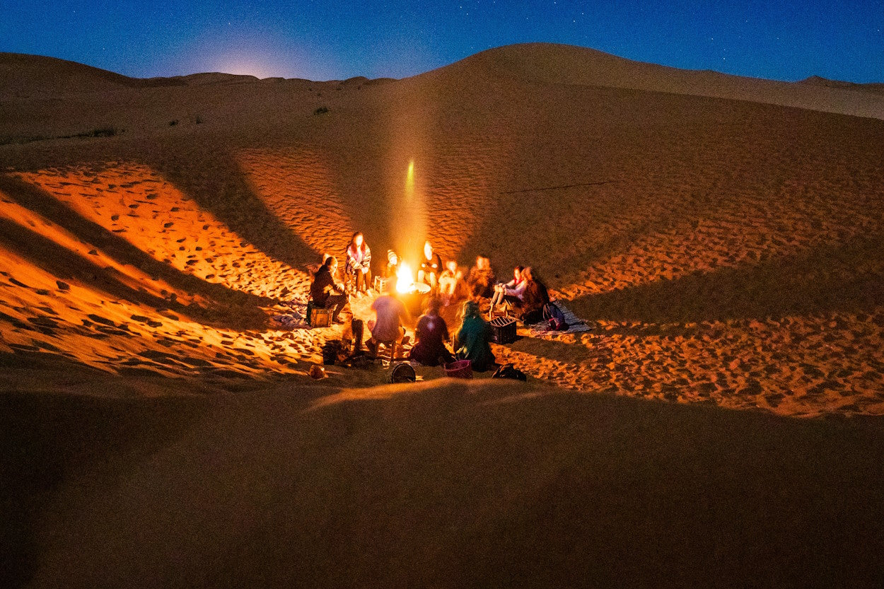 Friends around a campfire in the desert