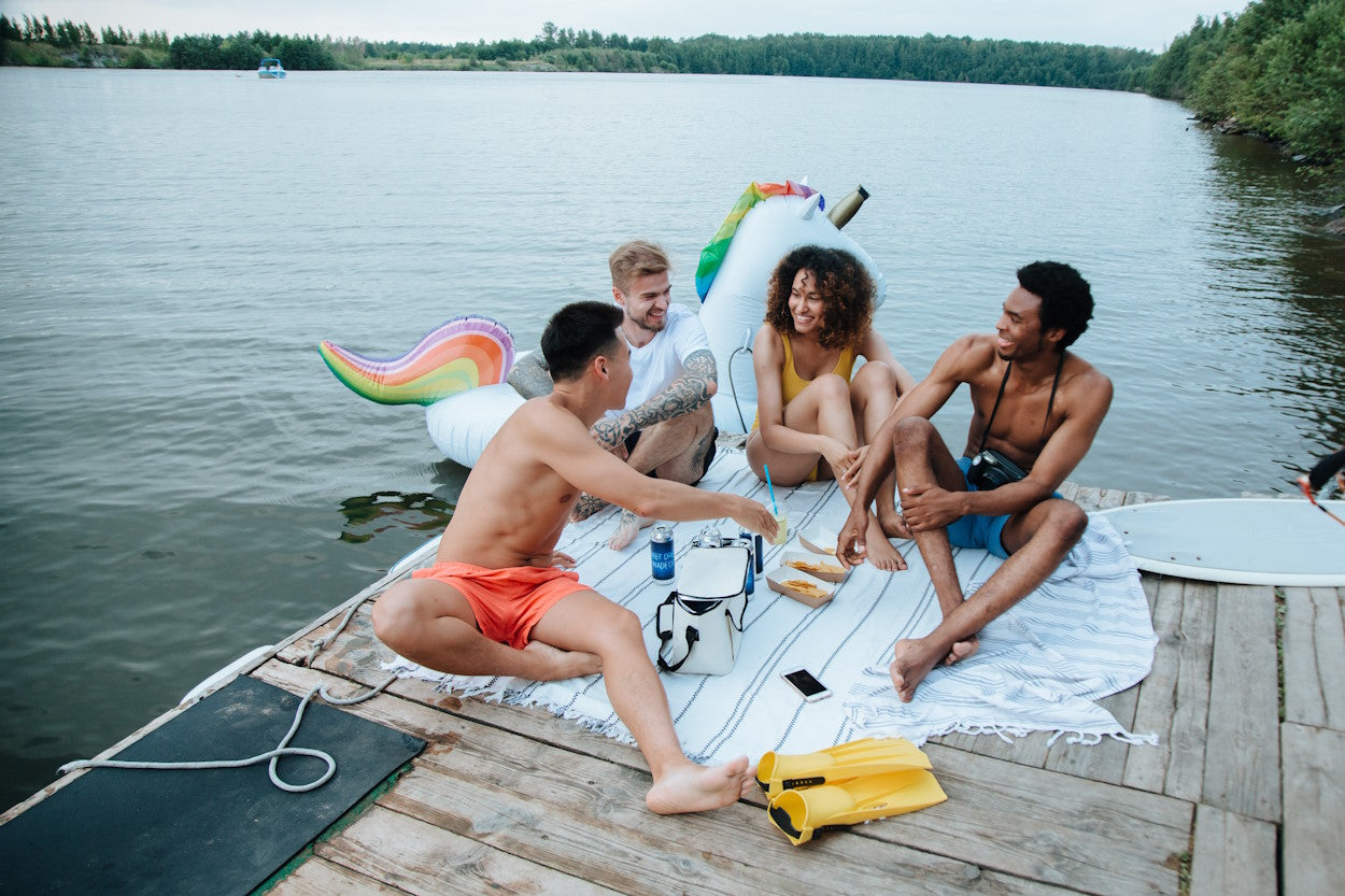 Friends hanging out on a dock on a lake