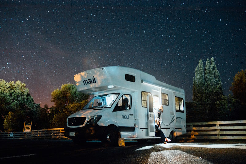 RV in parking lot at night