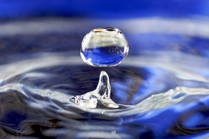 A droplet of water dropping into water