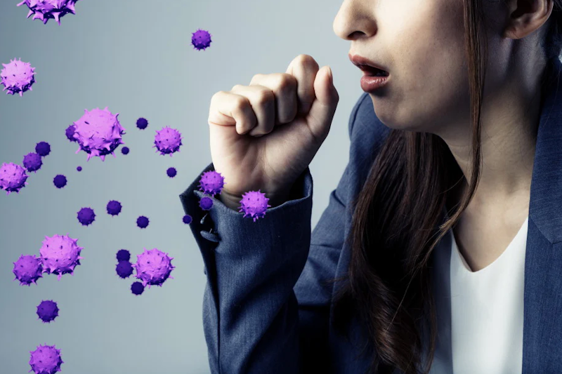 Woman coughing out simulated virus particles