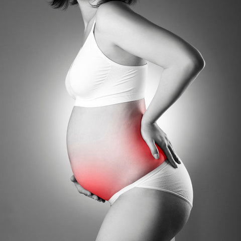 woman at the end of pregnancy with lower back pain