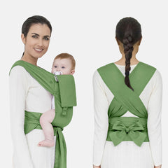 model with baby being carried correctly in a green mhug mei tai baby carrier