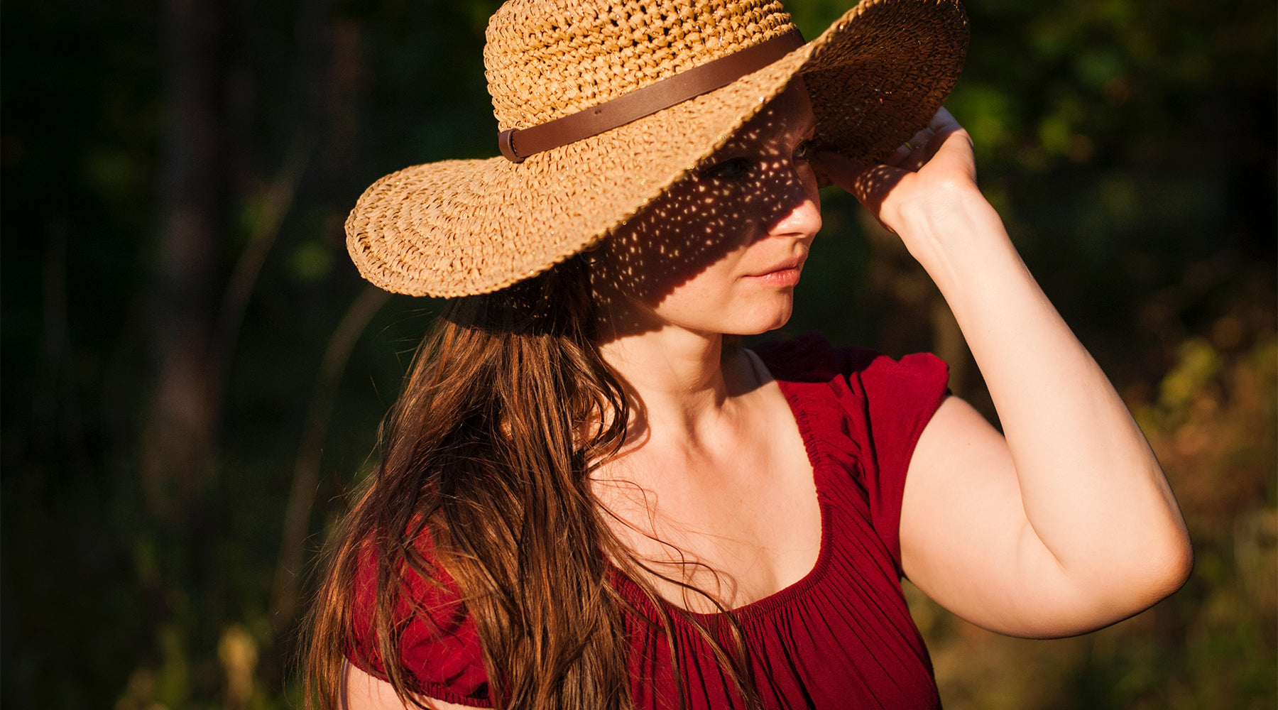 a woman protecting her hair from sun damage