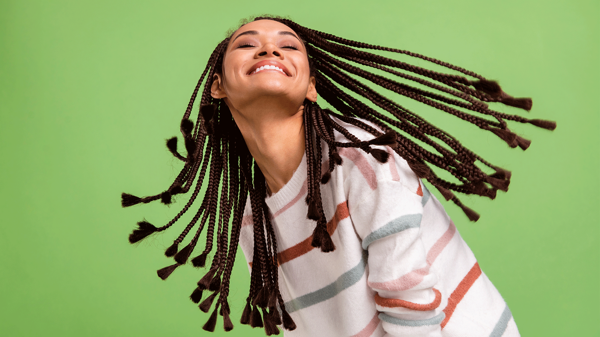 a woman with braids enjoying the benefits of henna for afro hair