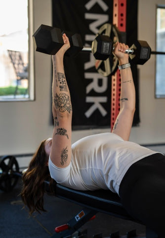 Woman performing Dumbbell bench press