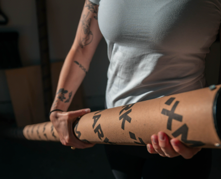 Woman holding barbell in delivery tube