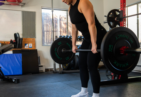 Woman doing barbell deadlifts