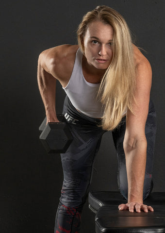 Woman performing dumbbell rows
