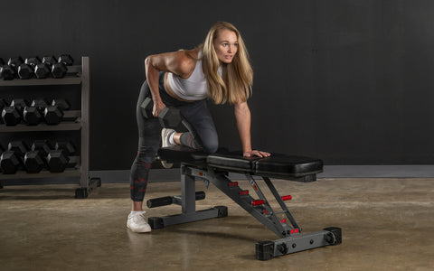 Woman performing rows on a bench