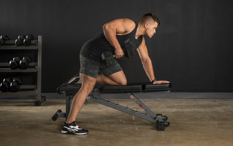 Man performing rows on a bench