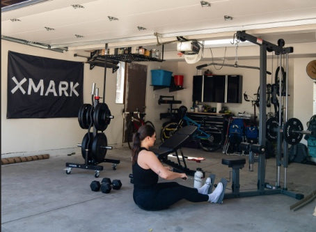 Woman using a row machine in garage gym