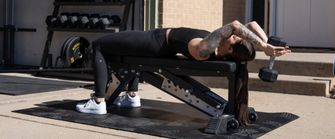 Woman performing Dumbbell Pullovers on a weight bench