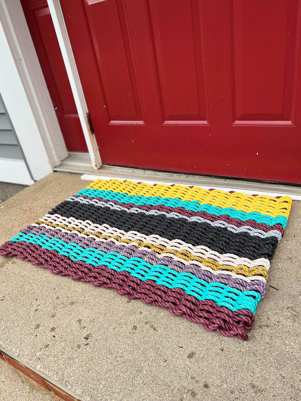 https://cdn.shopify.com/s/files/1/0709/2132/2805/t/5/assets/recycled-rope-mat-1677174282317_1000x.jpg?v=1677174283