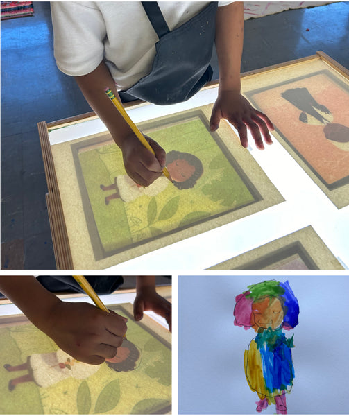 Students tracing images over transparencies atop a light table