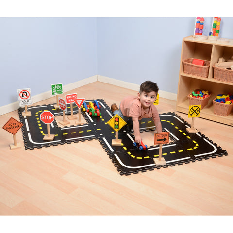 child playing with toy car on toy road