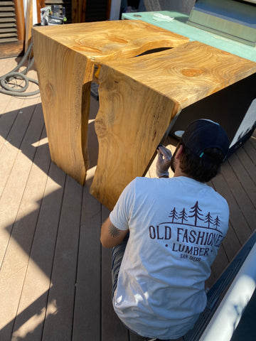 Custom waterfall bar top live edge installation on site in Solana Beach