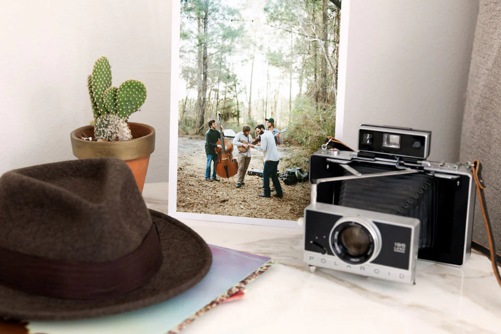 A film camera sitting next to a photograph