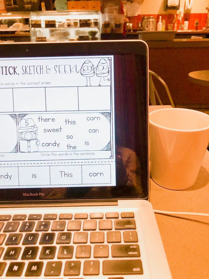 Teacher Lesson Planning in Coffee Shop on Laptop